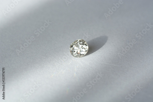 Antique vintage white old natural diamond loose gemstone setting with polished culet. Transparent precious natural cushion faceted European cut gem. Hardness 10. White background. Daylight shadows © Sergejs