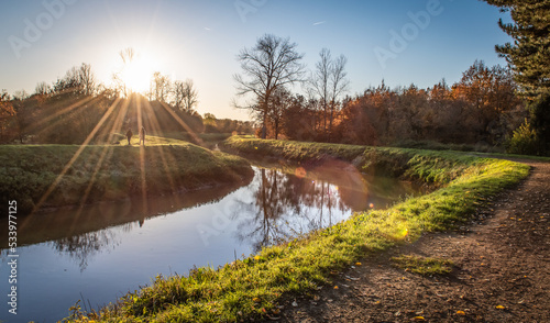 River landscape with hiking trail at sunset on a beautiful autumn evening in Flanders, Belgium. photo