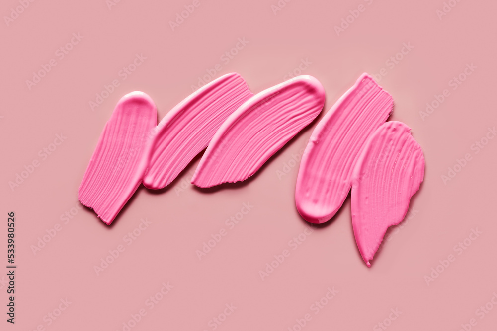 Pink eye shadows Samples on pink background. Swatches of cream makeup strokes
