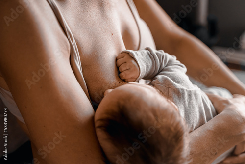 Mom  mummy  young mother with little baby daughter. Breast-feeding. Mum feeding child with breast milk.Newborn cute happy girl smiling in woman hands.Family happiness.Age parents parenting motherhood
