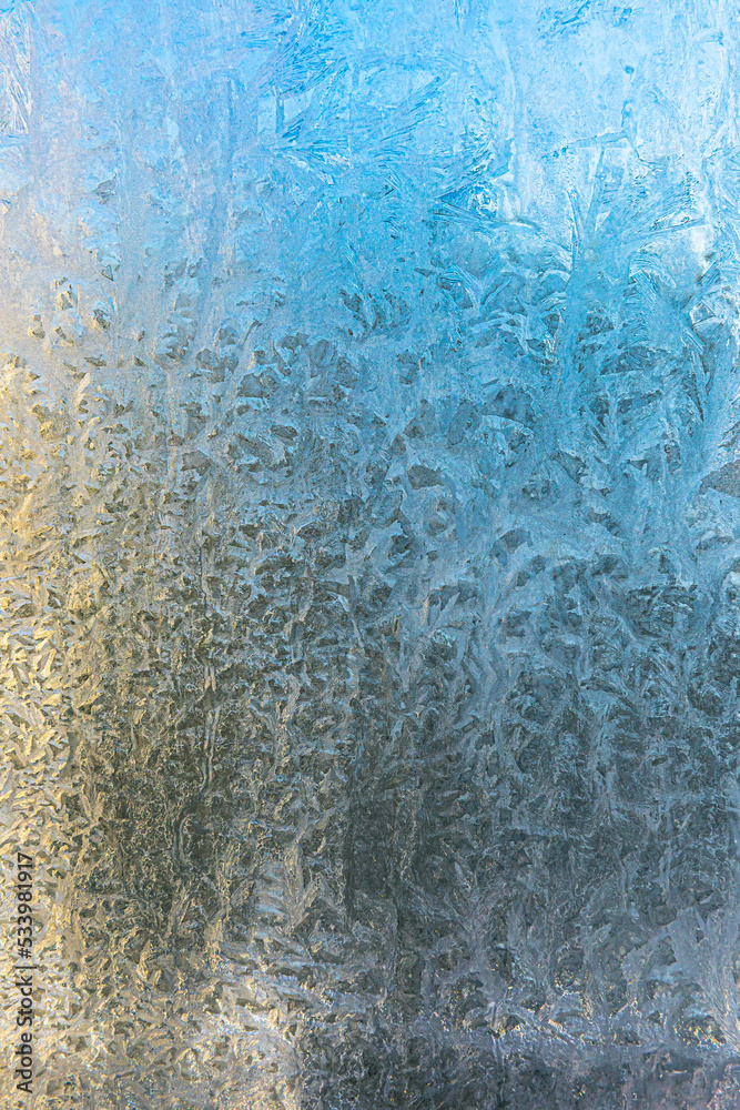 Frozen winter window with shiny ice frost pattern texture