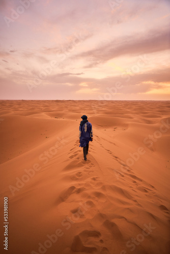 Man walking in the Sahara Desert (Traditional Moroccon clothing)