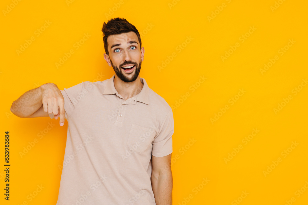 White brunette man with beard smiling while pointing finger upward White brunette man with beard smiling while pointing finger upward