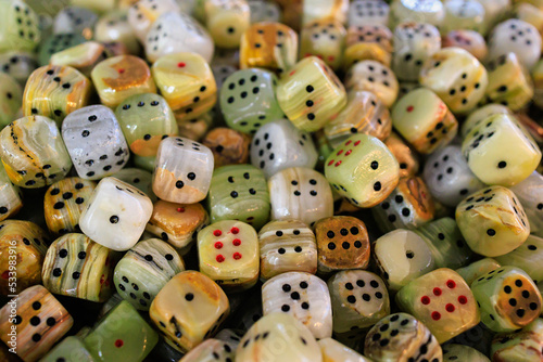 Dice made of natural stone. Background with selective focus and copy space