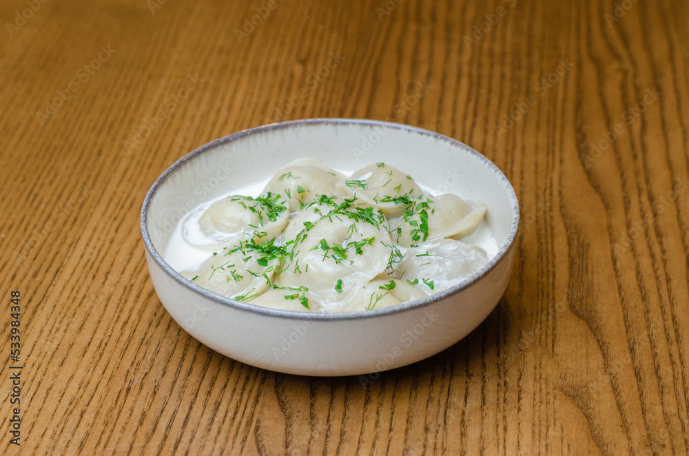 dumplings in sour cream in a plate dumplings in sour cream in a plate