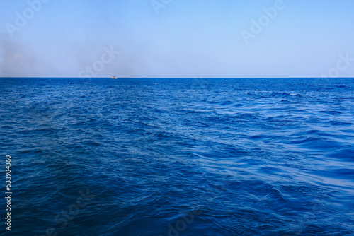 Black smoke from a yacht or ship on the high seas. Problems of ecology and environmental pollution. Background