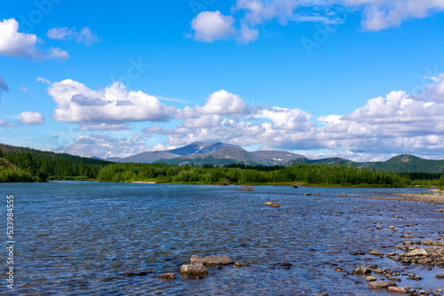 The Northern river against the background of mountains. The Sob River in Russia.