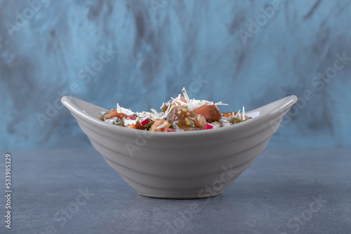  A bowl of mixed grated vegetables, on the marble background