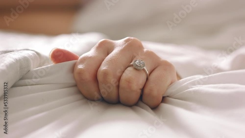 Married woman hands, bedroom and sex, love and intimate romance at home. Closeup fingers of sensual, erotic and orgasm female pulling bedsheet in sexual passion, desire and ecstasy on honeymoon photo