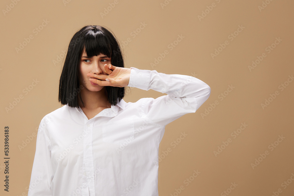 Pretty sexy beautiful stylish adorable brunet lady in white shirt posing isolated on pastel beige studio background. Copy space Banner Offer. Pulp Fiction concept. Fashion Cinema Pretty sexy beautiful stylish adorable brunet lady in white shirt posing isolated on pastel beige studio background. Copy space Banner Offer. Pulp Fiction concept. Fashion Cinema