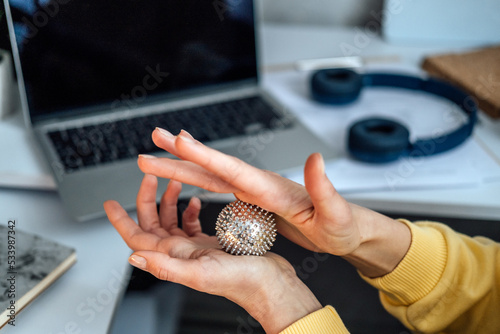 Hand massage Acupuncture Su Jok ball for hands and fingers. Sujok, su jok, su-jok traditional Chinese medicine therapy massage. Sujok Pain Therapy Finger Massager Circulation balls on female hands photo