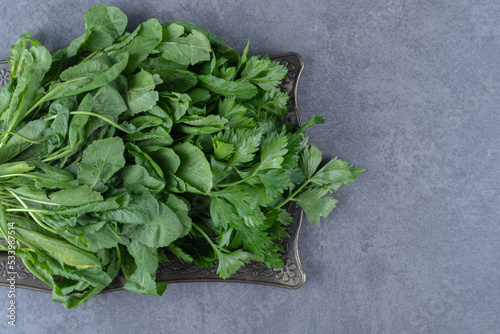 Fresh watercress on a tray, on the marble background