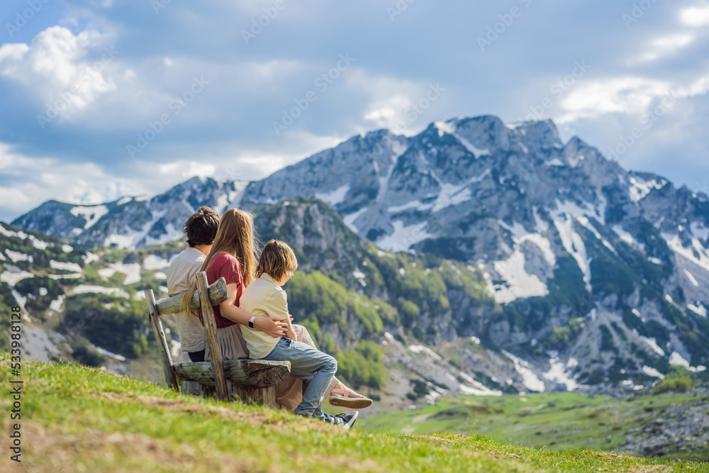 Family of tourists mom, dad and son in Mountain lake landscape on Durmitor mountain in Montenegro beautiful Durmitor National park with lake glacier and reflecting mountain Portrait of a disgruntled