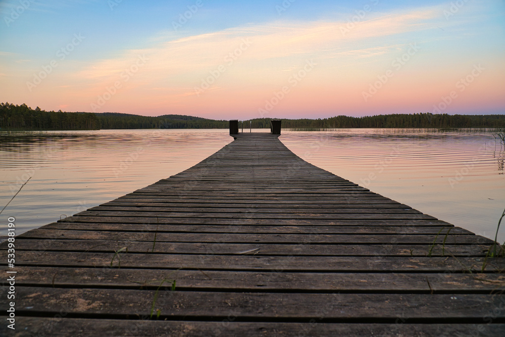 Wooden jetty reaching into a swedish lake at blue hour. Nature from Scandinavia