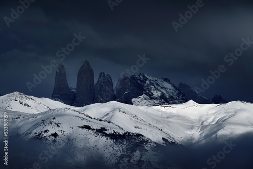Winter lanscape from Patagonia moutains with snow. Lago Nordenskjold, Torres del Paine National Park, Chile. Twilight blue evening sky. Traveling in Chile,  hills in Torres del Paine NP. © ondrejprosicky