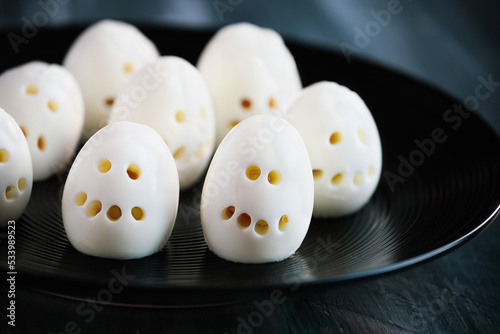 Fun food for kids. Hard boiled skeleton skull eggs perfect for Halloween parties. Alternative to candy. Shallow depth of field with selective focus. Blurred foreground and background. 