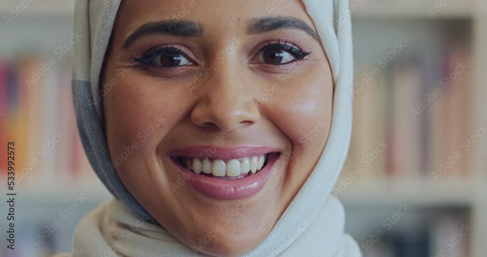 Muslim arab woman face, portrait and smile from Saudi Arabia wearing traditional headscarf, hijab and islamic religion. Happy, holy and young arabic student studying, learning and university library
