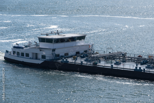 Barge with pipelines on the deck for industrial transport of oil and gas