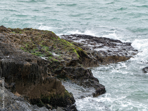 Wild rocks and sea water, landscape, rock formation beside body of water. Ocean waves