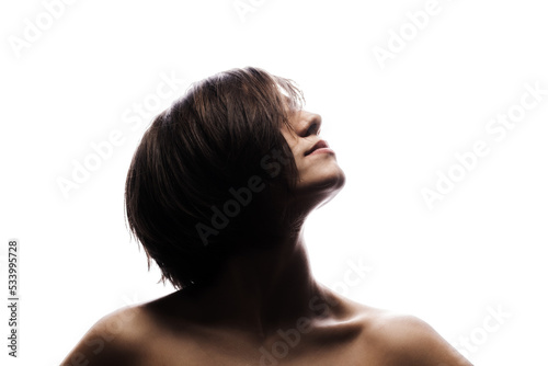 Half silhouette portrait of a girl with short hairstyle. Isolated against white background. .