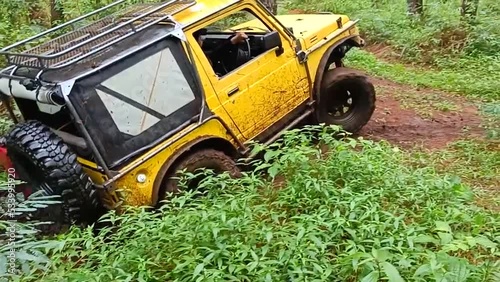 off road car ride on tropical jungle dirt road in slow motion photo