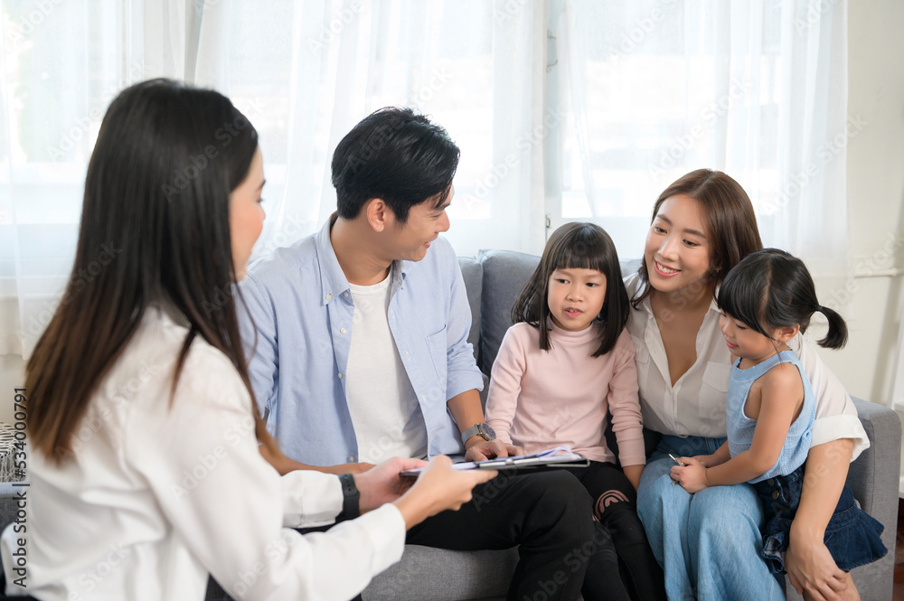 Asian family meeting with female real estate agent or insurance consultant offering promotions , Mortgage, loan, property and medical health insurance concept. Asian family meeting with female real estate agent or insurance consultant offering promotions , Mortgage, loan, property and medical health insurance concept.