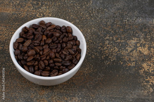 Aromatic coffee beans in white bowl