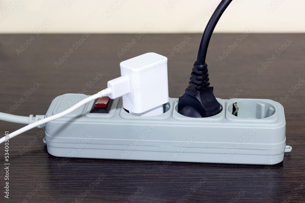 electrical socket, extension cord with electrical appliances turned on, the concept of saving