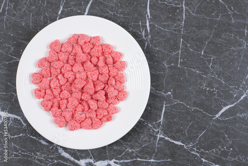 Pink cereal flakes on white plate