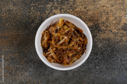 Caramelized onion pieces in white bowl