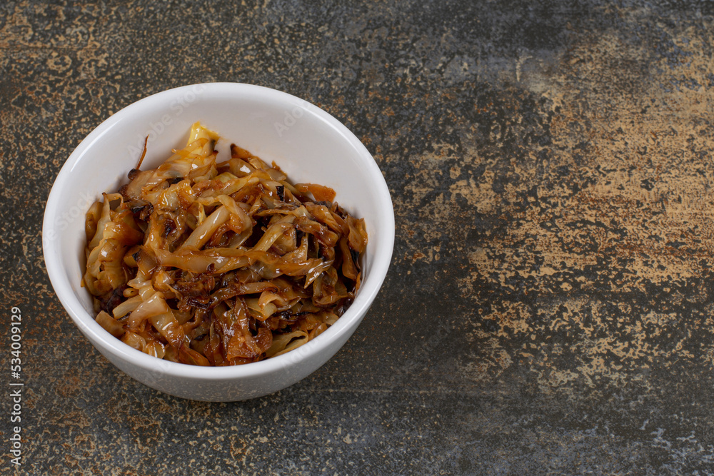 Caramelized onion pieces in white bowl Caramelized onion pieces in white bowl