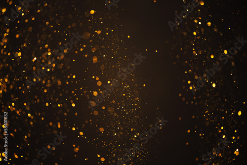 Warm glowing gold glitter festive lights abstract bokeh dark texture background overlay