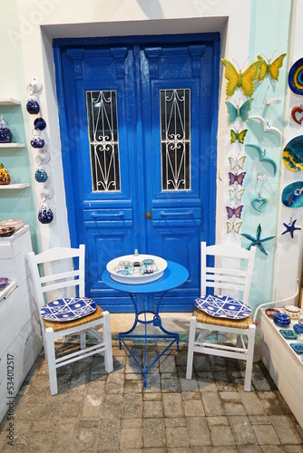 Die blaueTür mit den Stühlen in Pigadia photo