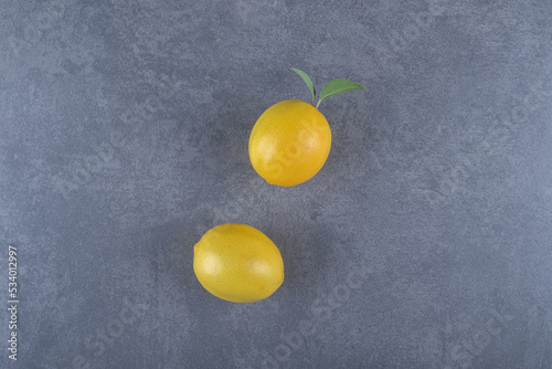 Two fresh lemon on grey background