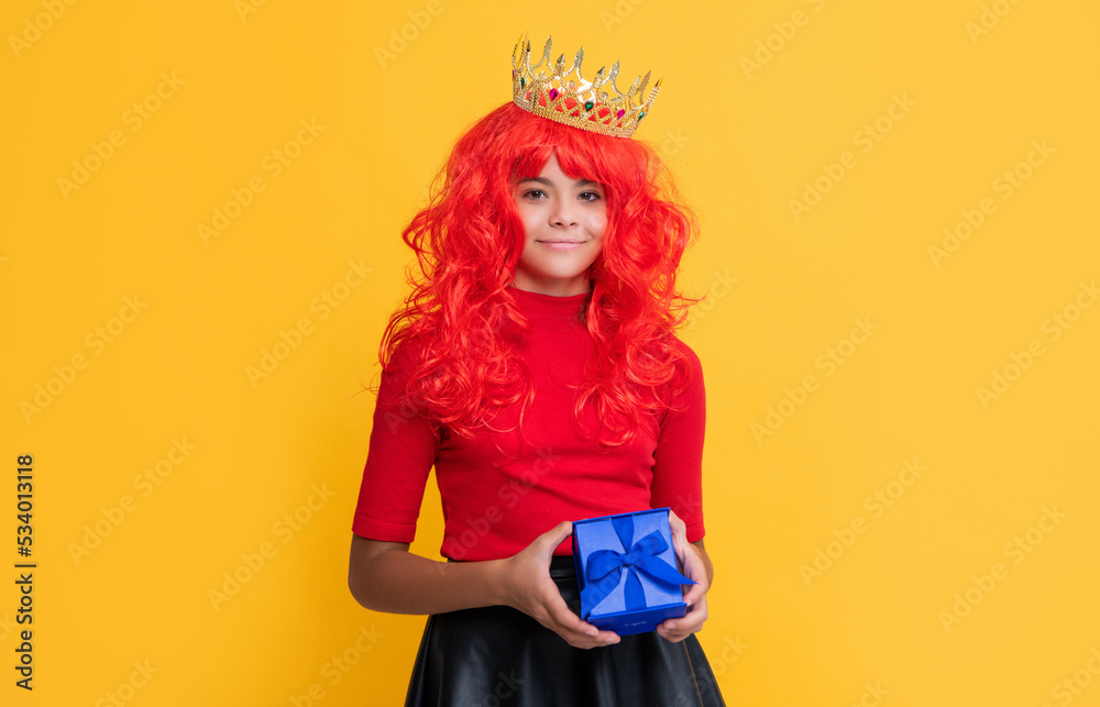 positive child in crown with present box on yellow background