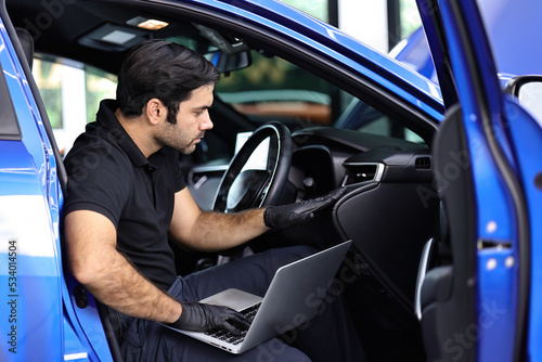 The car's electronic programming uses the laptop to link and checks the data in the engine by monitoring the digitization display to keep and tune the best performance of the engine in the car repair.