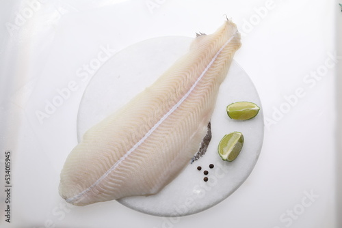 Lemon sole fillet on a white background, a packshot photo for fish shop, top view.