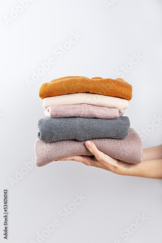 Fotografie Donating old warm clothes, second hand, economic crisis, fighting the cold, warm clothes, saving money