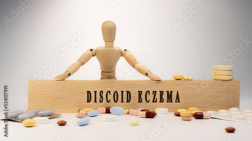 discoid eczema disease. Written on wooden surface. On wood and medicine concept. white background. Diseases and treatments photo