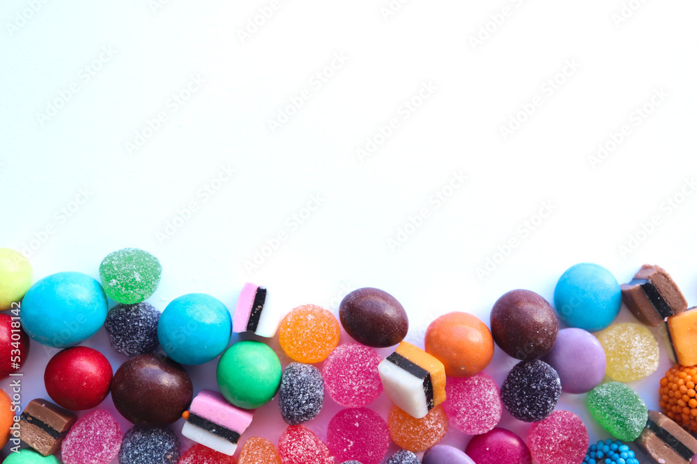 Sweets border on white background. Mixed variety of sweets Sweets border on white background. Mixed variety of sweets