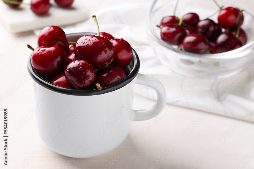 Fresh ripe cherries with water drops on white wooden table, closeup Fresh ripe cherries with water drops on white wooden table, closeup