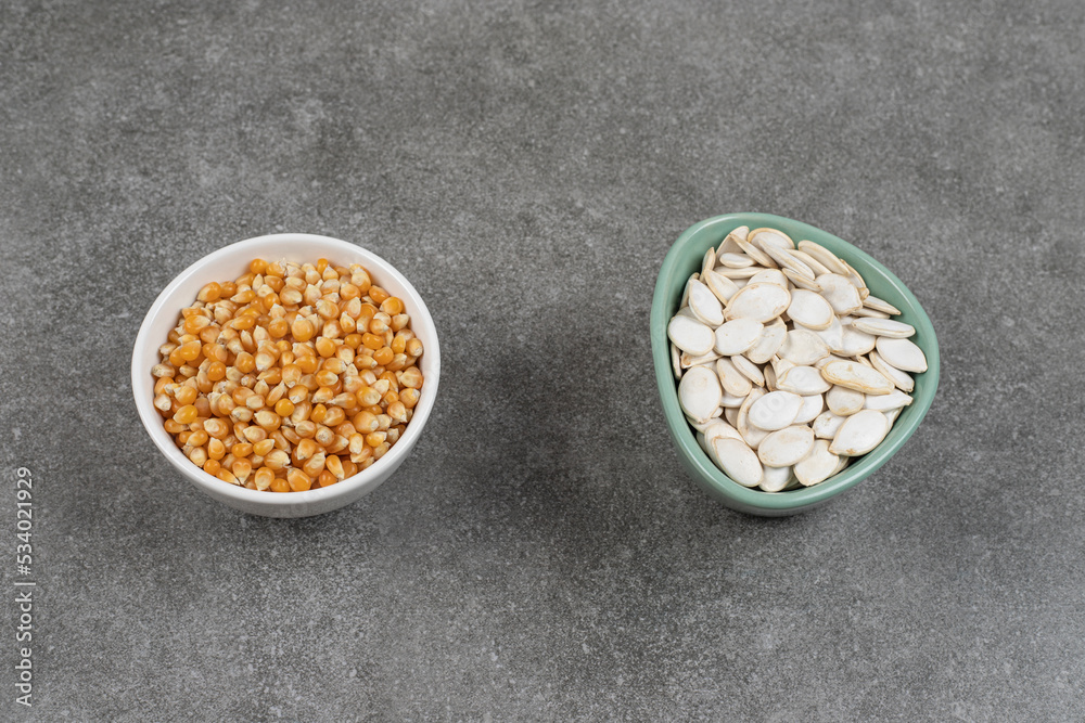 Pile of raw corn kernels on ceramic plate Pile of raw corn kernels on ceramic plate