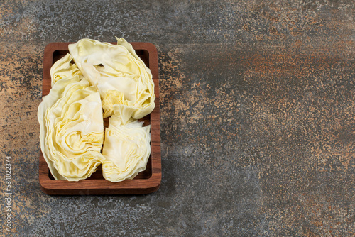 Delectable cabbage in the tray , on the marble background