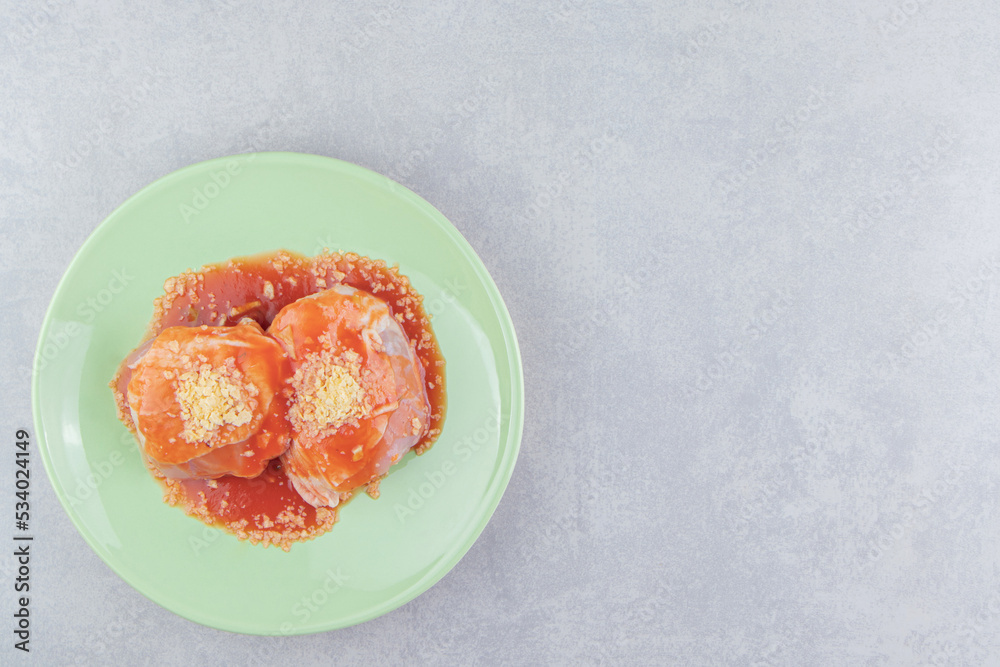 Ketchup meat with spice on the plate , on the white background Ketchup meat with spice on the plate , on the white background