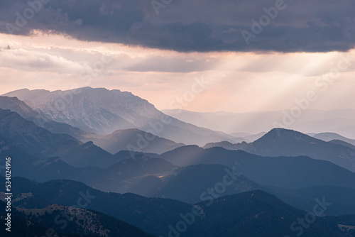 Amazing sunset rays of light over the mountain ridge.