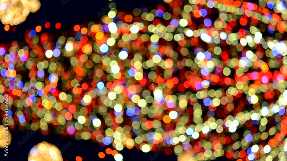 New Year's Christmas tree decorated with luminous multi-colored garlands and illumination at night. Christmas tree with flashing lights. Blurred background. New Year Christmas holidays. New Year's Christmas tree decorated with luminous multi-colored garlands and illumination at night. Christmas tree with flashing lights. Blurred background. New Year Christmas holidays.