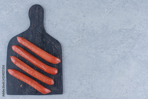 Easy snack salami on the black cutting board photo