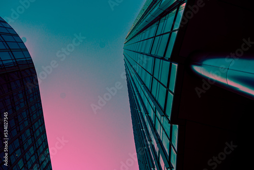 Modern office building in the evening. Facade turquoise mirror	