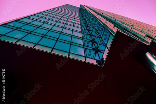Modern office building in the evening. Facade turquoise mirror	
