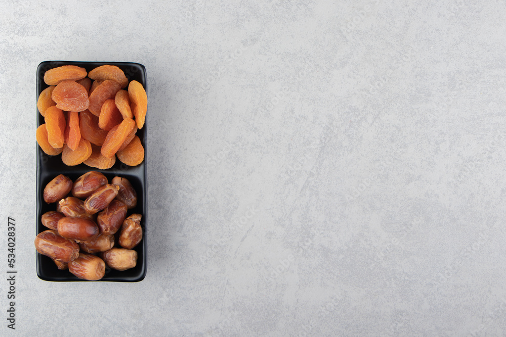 Dried fruits in the bowl , on the marble background Dried fruits in the bowl , on the marble background